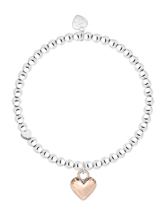 Silver beaded bracelet with a rose gold heart charm on a white background