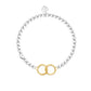 Silver bracelet with a gold interlocking circle charm on a white background