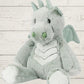 A gray plush toy resembling a dragon with a soft fabric body, designed for young children.