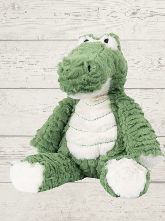 A plush toy resembling a green marshmallow with a crocodile-like face, made from soft fabric, designed for cuddling and play.