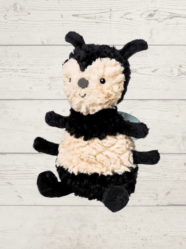 Plush bee soft toy on a light wooden background