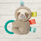 Plush sloth toy with teething ring on a wooden surface