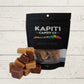 mixed fudge with packaging with Kapiti Candy co on it on a wooden surface