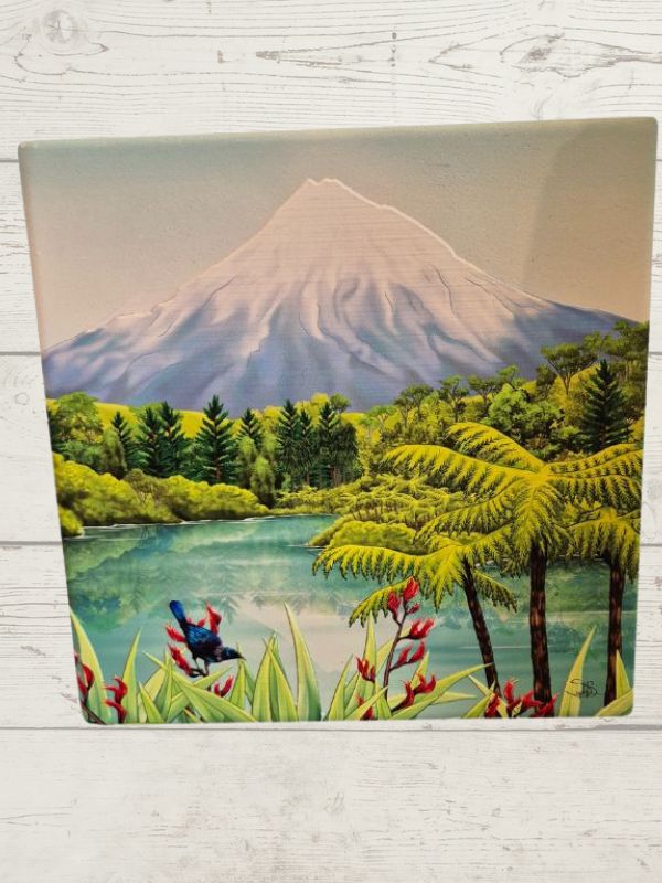 Ceramic tile featuring a scenic view of Mount Taranaki with green trees and a blue sky.