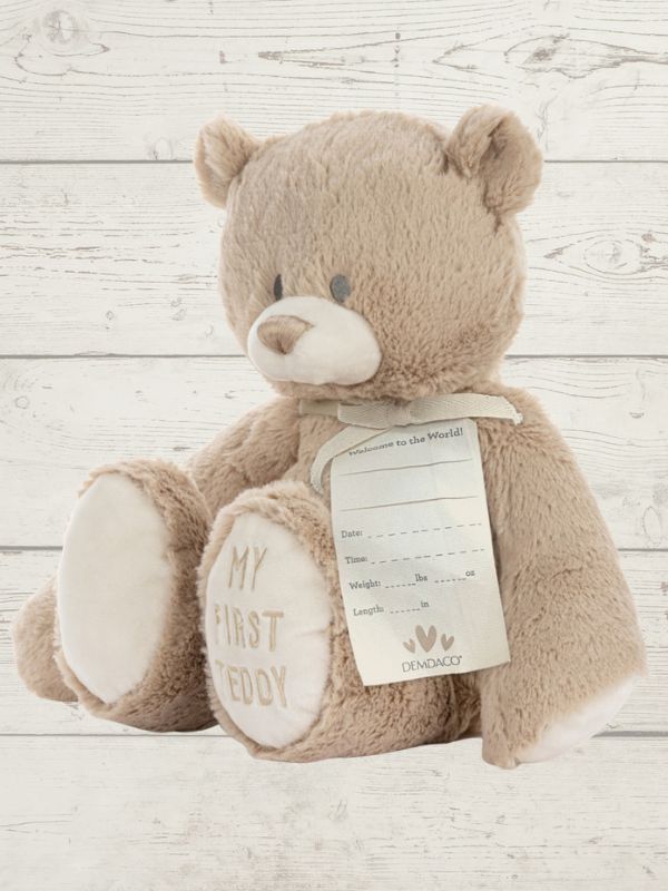 Teddy bear with a tag on a wooden surface