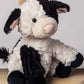 A plush toy resembling a cow with black and white fur, featuring embroidered eyes and a soft texture.