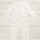 White baby onesie with small patterns on a light wooden surface