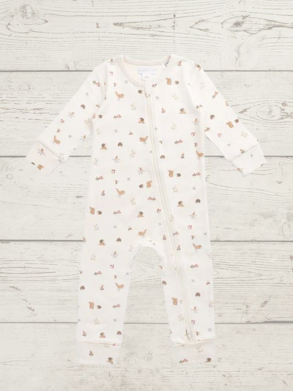 White baby onesie with small patterns on a light wooden surface