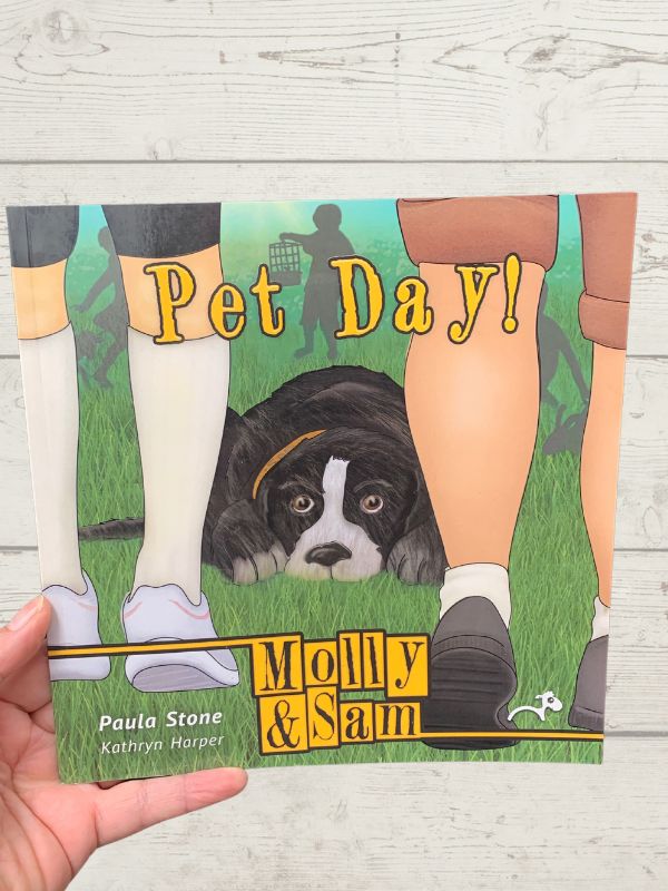 A paperback children's book titled 'Pet Day' featuring illustrations of a dog and people's legs on the cover.
