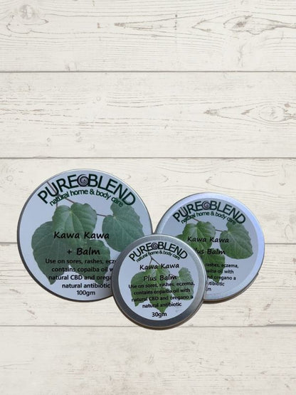 Three containers of Pure Blend Kawa Kawa Plus Balm on a light wooden surface