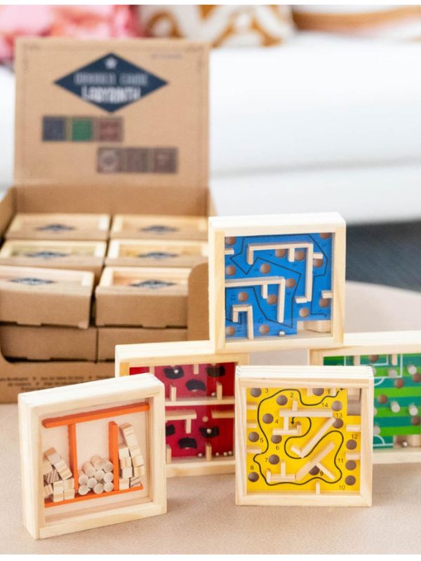 Wooden puzzle blocks with geometric designs on a wooden surface.