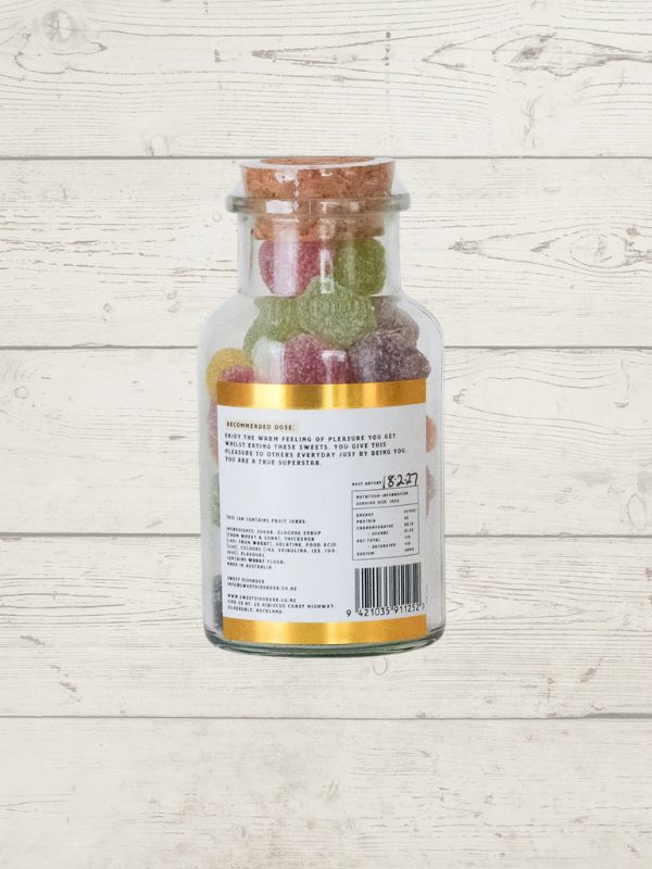 Jar of fruit gummies on a wooden surface