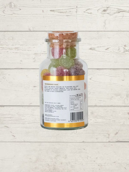 Jar of fruit gummies on a wooden surface