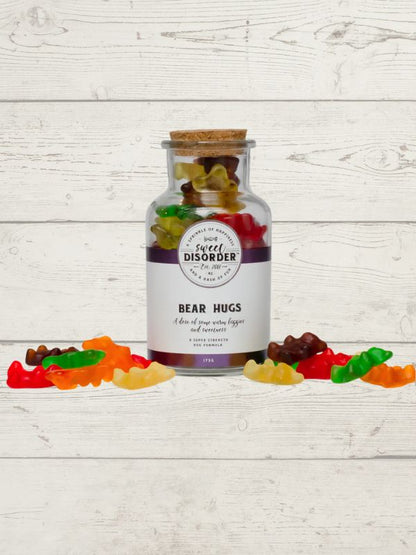 Jar labeled 'Bear Disorder' with gummy bears on a wooden surface