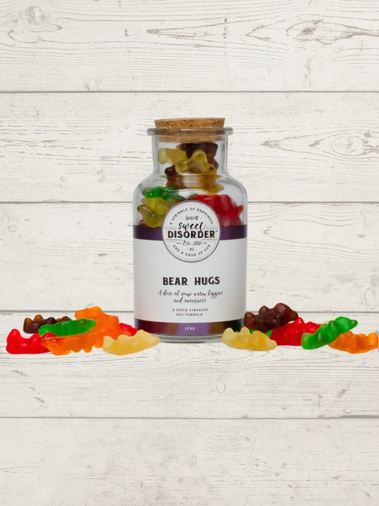 Jar labeled 'Bear Disorder' with gummy bears on a wooden surface