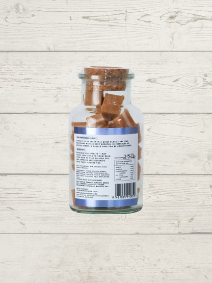 Glass jar with a label on a wooden surface