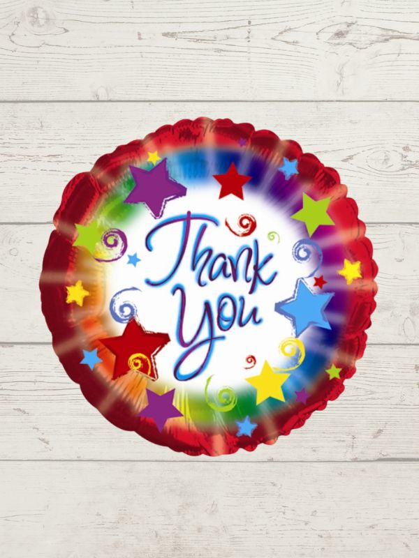 A colorful balloon with the words 'Thank You' in the center, surrounded by star graphics on a wooden background.