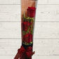 three red roses in black cylinder with red ribbon