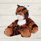 Plush tiger toy on a light wooden surface