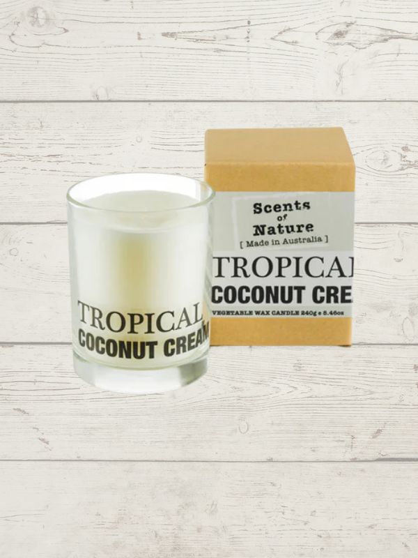 Tilley scented candle coconut cream displayed in a glass jar with packaging on a white wooden background. 