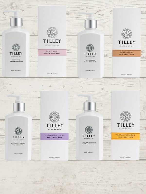 A collection of Tilley body wash bottles in various scents, including lavender, vanilla, and patchouli, with packaging that displays the scent name and minimalist design.