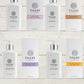 A collection of Tilley branded room spray bottles displayed against a wooden background. The bottles are varied in size and design, with a consistent white and silver label design featuring the Tilley logo.