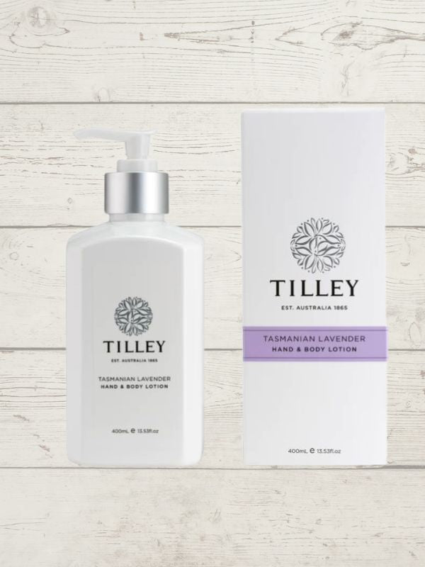 A collection of Tilley branded room spray bottles displayed against a wooden background. The bottles are varied in size and design, with a consistent white and silver label design featuring the Tilley logo.