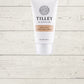 Tilley hand and nail cream tube on a wooden surface.