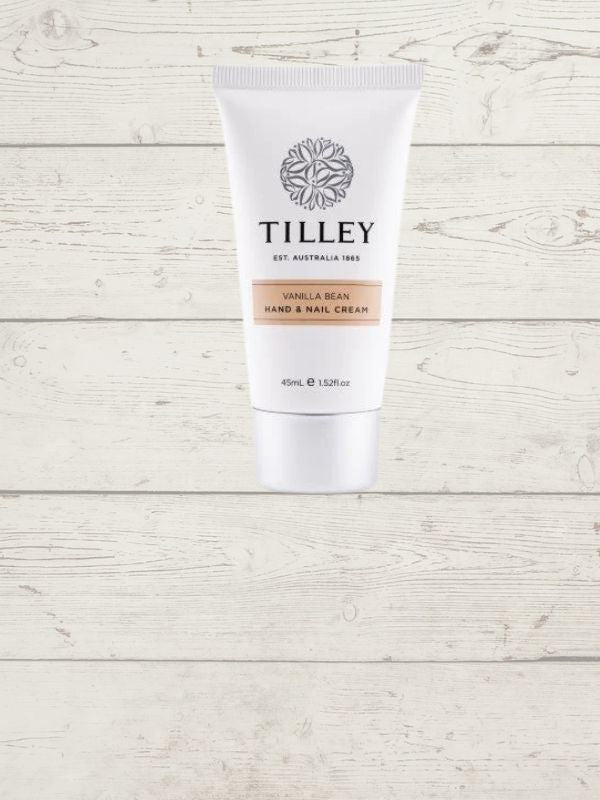 Tilley hand and nail cream tube on a wooden surface.