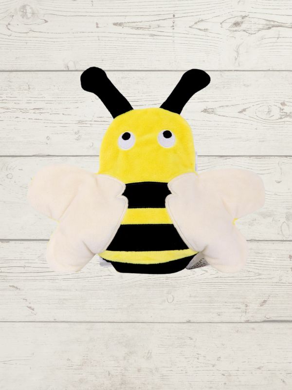 Plush toy shaped like a bee on a wooden surface