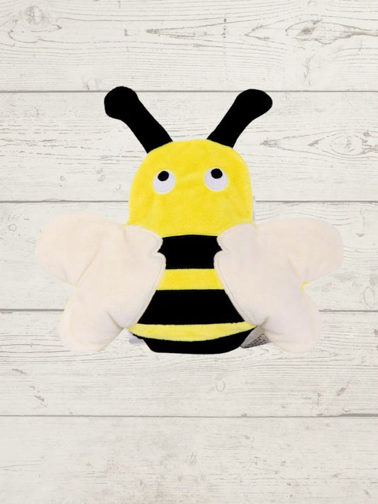 Plush toy shaped like a bee on a wooden surface
