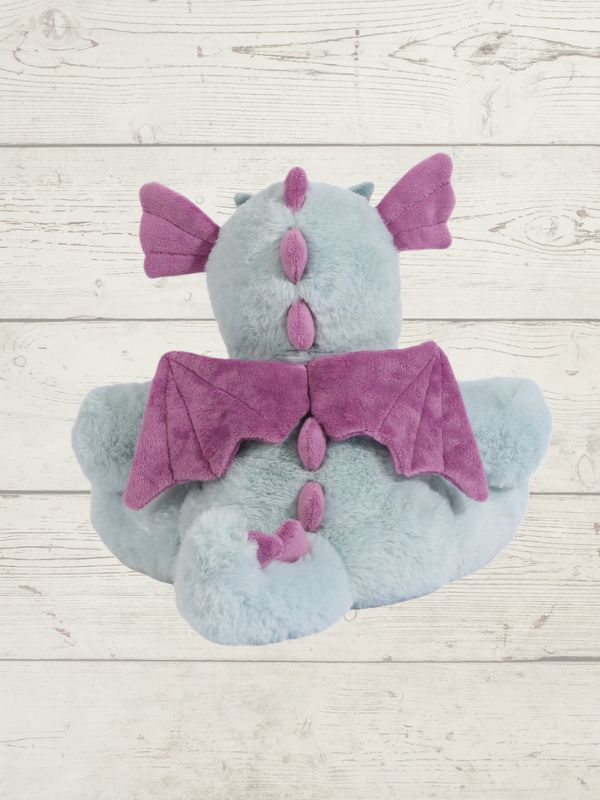 Plush toy with purple accents on a wooden surface