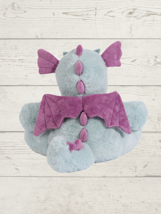 Plush toy with purple accents on a wooden surface