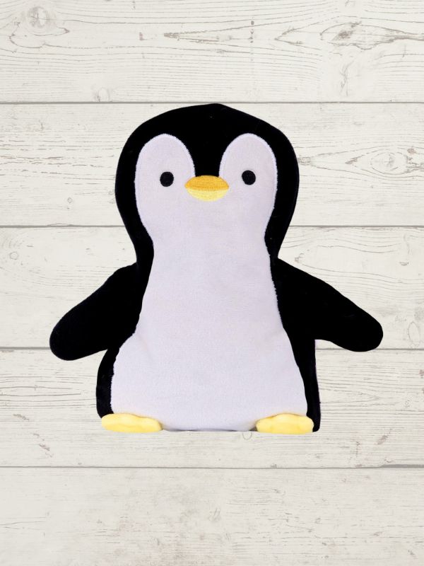 Plush penguin toy on a light wooden surface