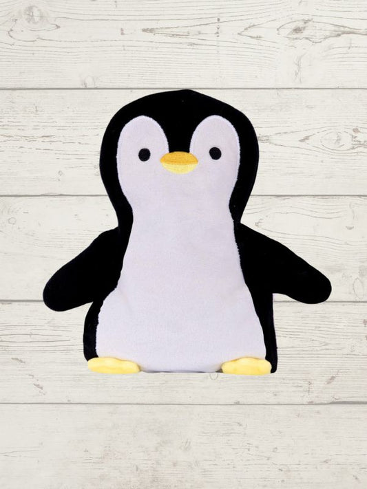 Plush penguin toy on a light wooden surface