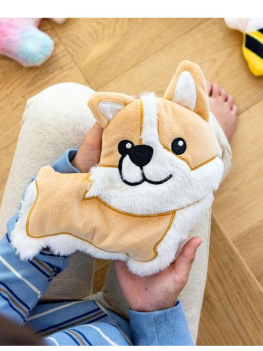 Plush dog toy held by a person on a wooden floor