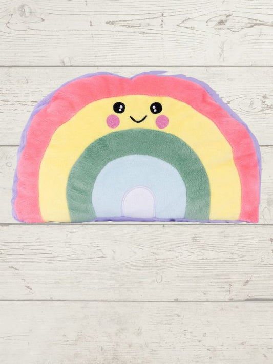 Plush rainbow-shaped pillow with a smiley face on a wooden surface