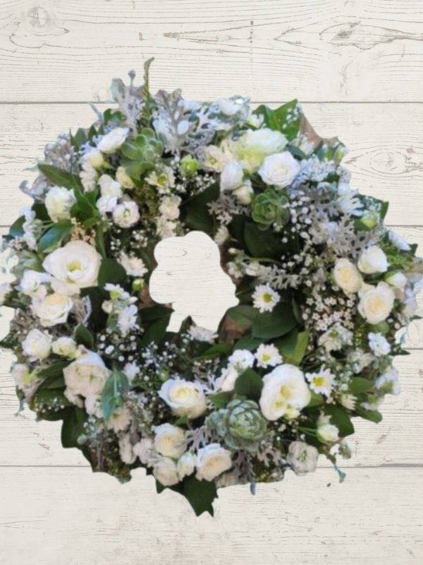A white and green Sympathy wreath with a mix of white and green flowers, designed to be held in a hand.