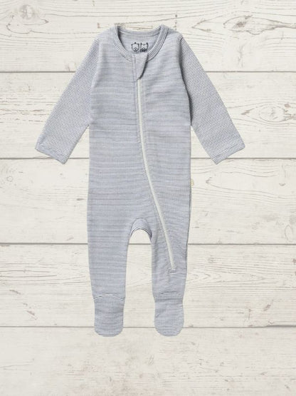 A long sleeve rib zipsuit for babies, with feet and fold-over mittens, in a blue color, displayed on a wooden background.