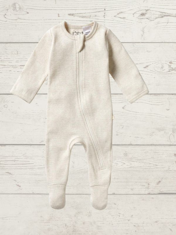 A long sleeve rib zipsuit for babies, with feet and fold-over mittens, in a gray color, displayed on a wooden background.