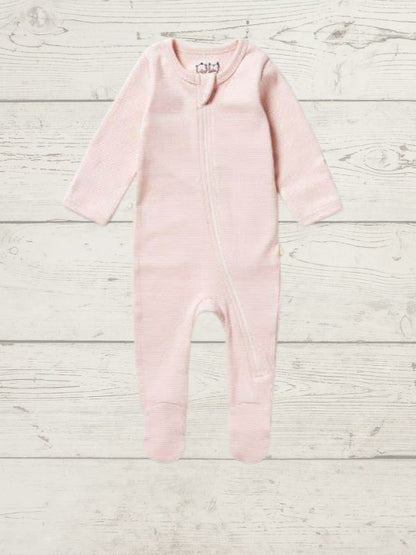 A long sleeve rib zipsuit for babies, with feet and fold-over mittens, in a gray color, displayed on a wooden background.