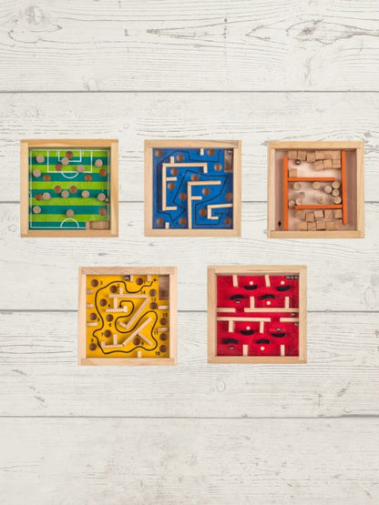 Five wooden maze toys in different colors on a light wooden surface