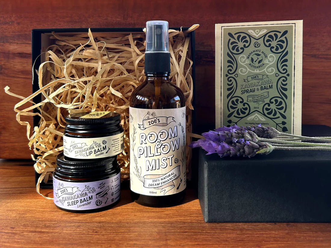 Collection of natural products including a bottle labeled 'Room Pillow Mist' and jars on a wooden surface.