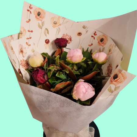 Peony bouquet, stunning InSeason peonies in a variety of colours.  Bouquet of mixed peonies and foliage displayed in a wrapped water filled container. 